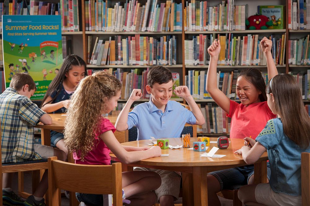 Children participating in a nutrition education activity at a summer meal site in a library. Original public domain image…