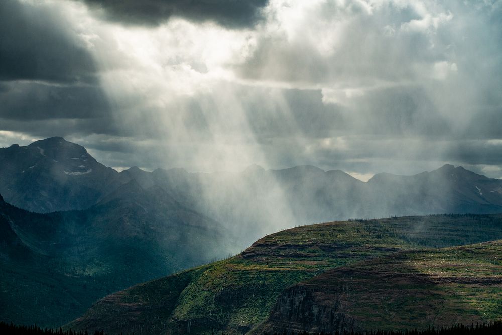 Stormy skies move across a wide mountain landscape. Original public domain image from Flickr
