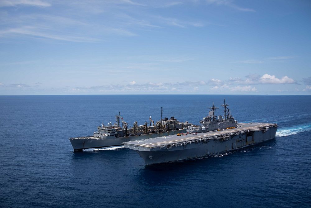  The Wasp-class amphibious assault ship USS Kearsarge sails alongside the fast combat support ship USNS Arctic to prepare…