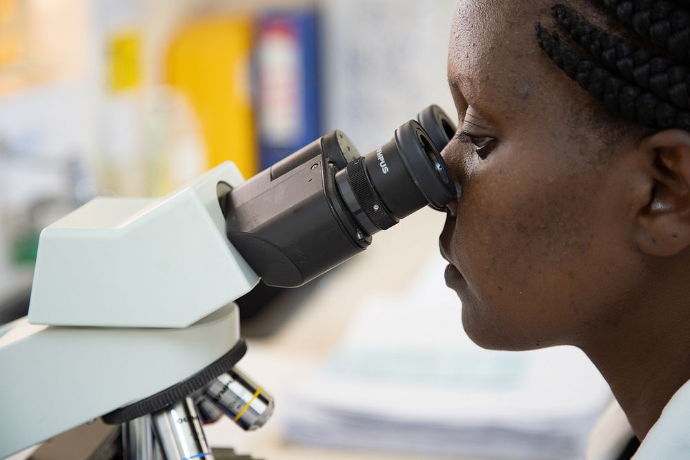 Laboratory Technologist Caren Cherotich (31 years) uses a microscope to examine samples at Ahero County Hospital, Kisumu…