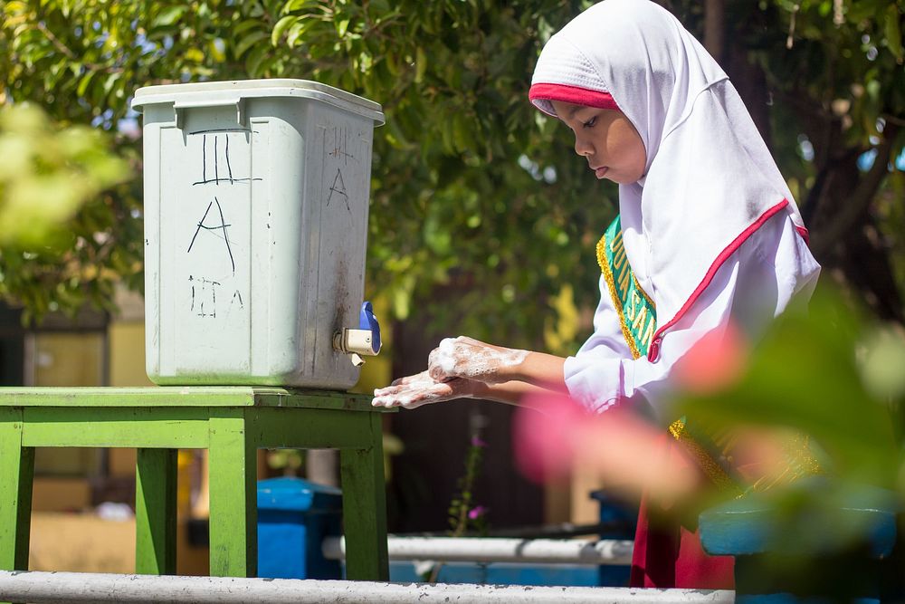 Girl washing hands. Original public domain image from Flickr