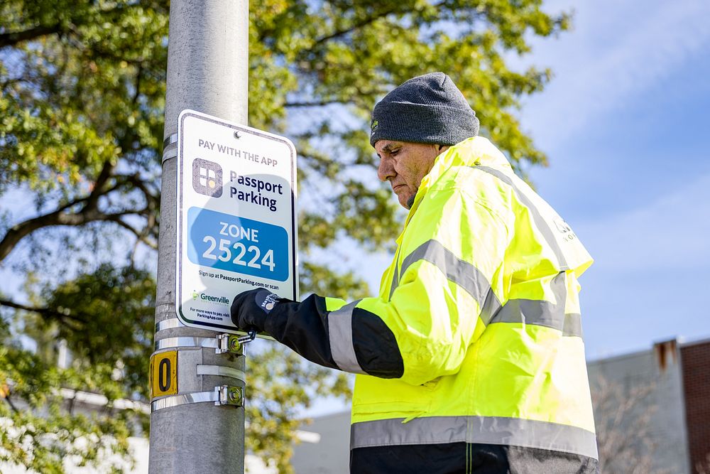Engineering and Parking Enforcement staff install new signage ahead of public parking changes in Uptown Greenville on…