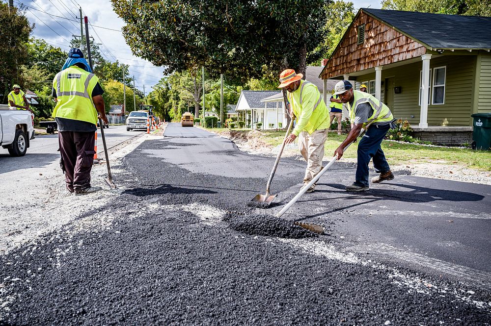 Construction on the greenway extension from Pitt Street to Memorial Drive nears completion as workers apply pavement to the…