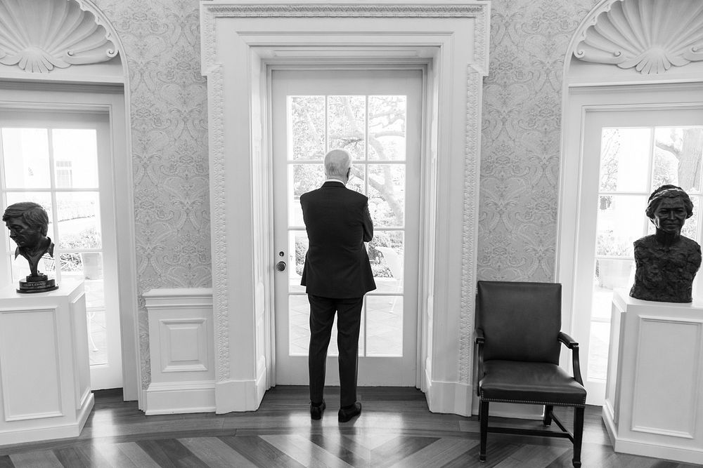 President Joe Biden looks out the window of the Oval Office, Friday, April 8, 2022. (Official White House Photo by Adam…