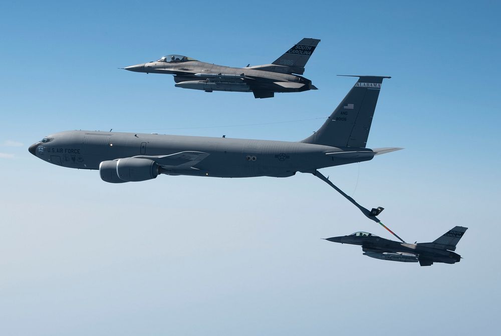 U.S. Air Force F-16 Fighting Falcons assigned to the South Carolina Air National Guard fly with a KC-135 Stratotanker…