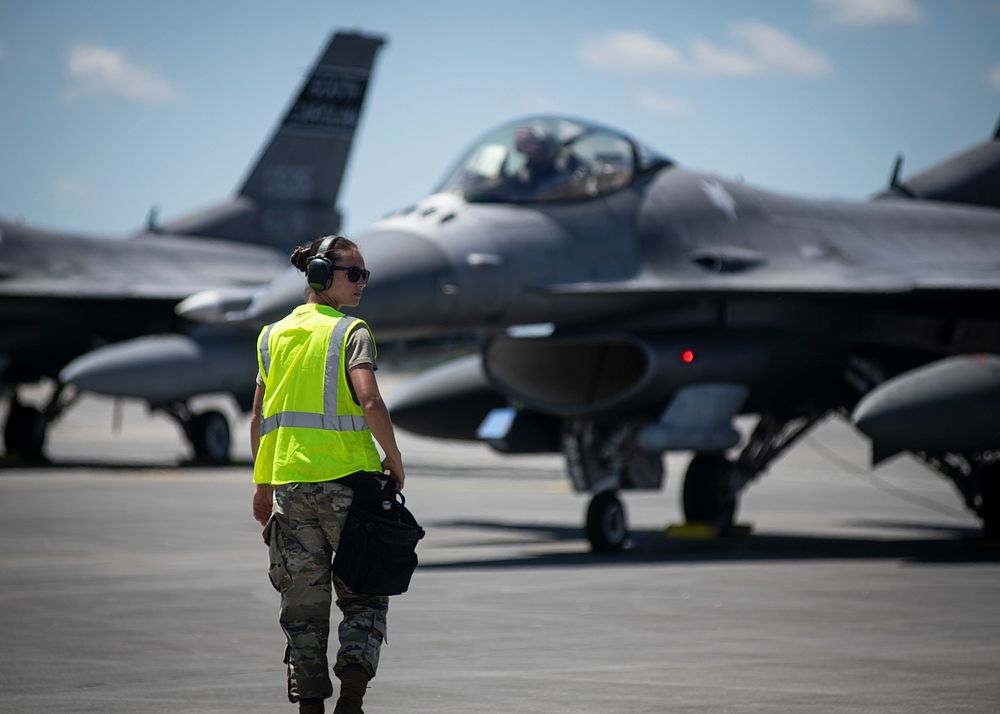 A U.S. Air Force crew chief assigned to the 157th Fighter Squadron, South Carolina Air National Guard, walks on the flight…