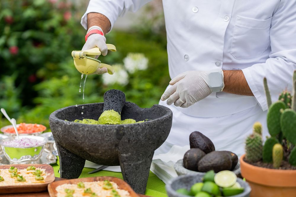 Kitchen staff prepares guacamole.