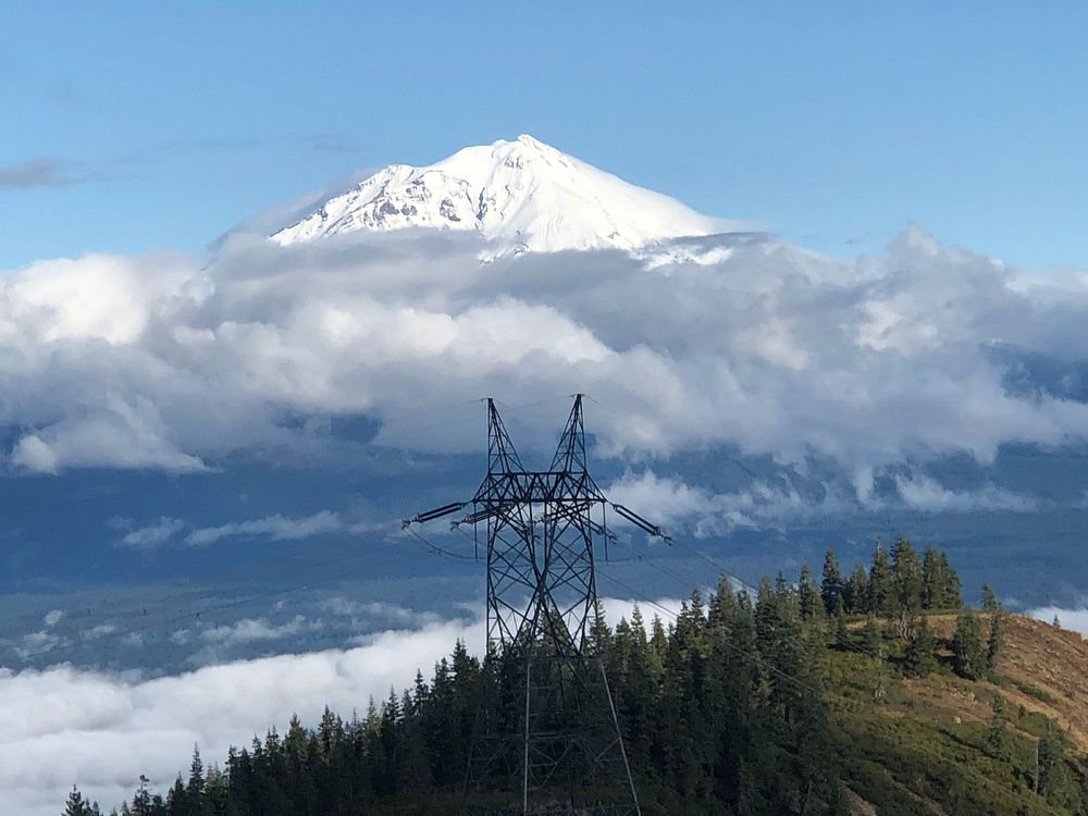 Mt Shasta rises behind a Western Area Power Administration (WAPA) transmission line.  For more information or additional…
