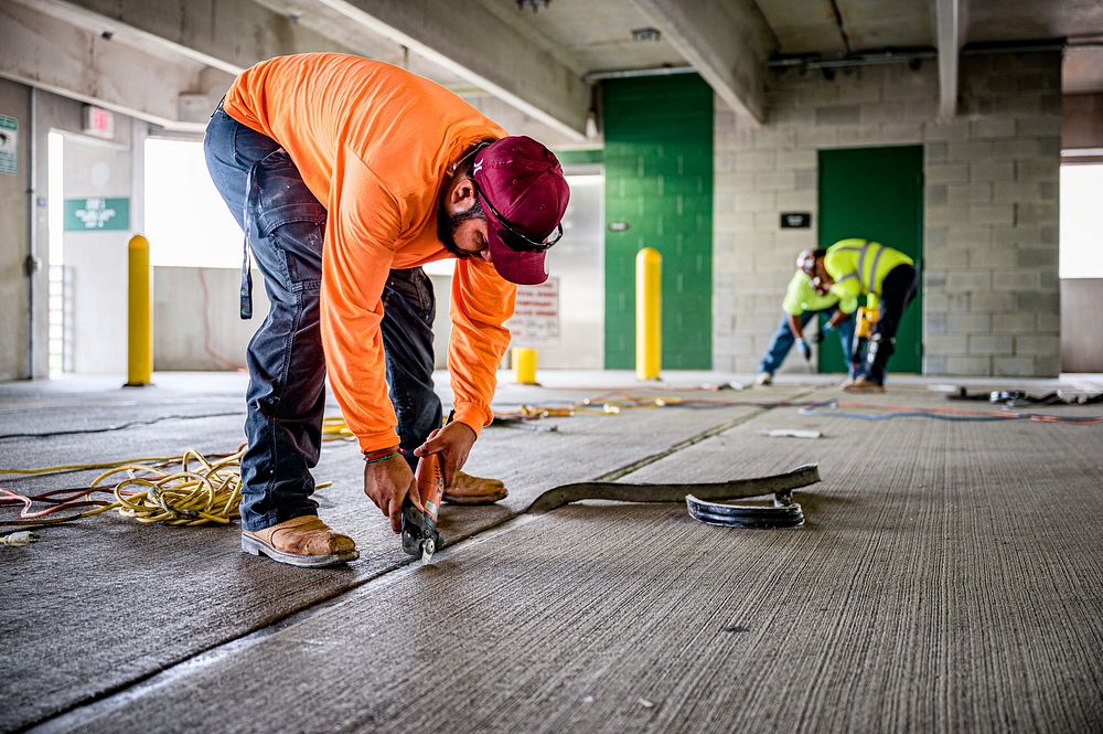 A contractor performs maintenance replacing all expansion joint seals on the 4th Street Parking Deck on Monday, July 11…