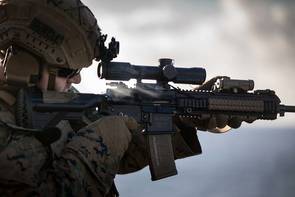 U.S. Marine Corps Lance Cpl. Jason Sewell, rifleman assigned to the 22nd Marine Expeditionary Unit (MEU), fires an M4…