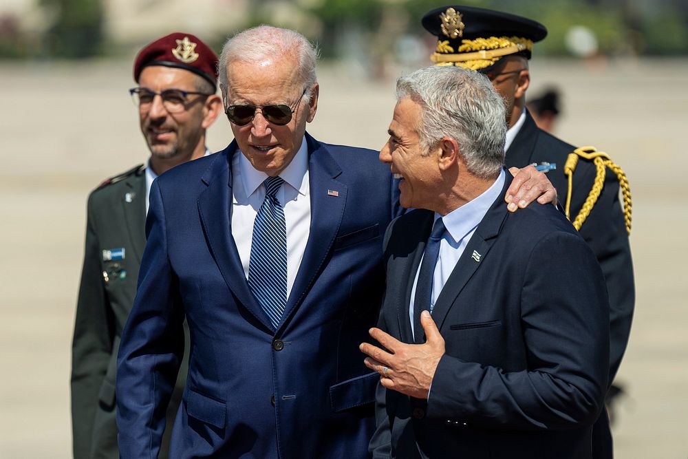 President Joe Biden greets Israeli Prime Minister Yair Lapid at an arrival ceremony, Wednesday, July 13, 2022, at Ben Gurion…