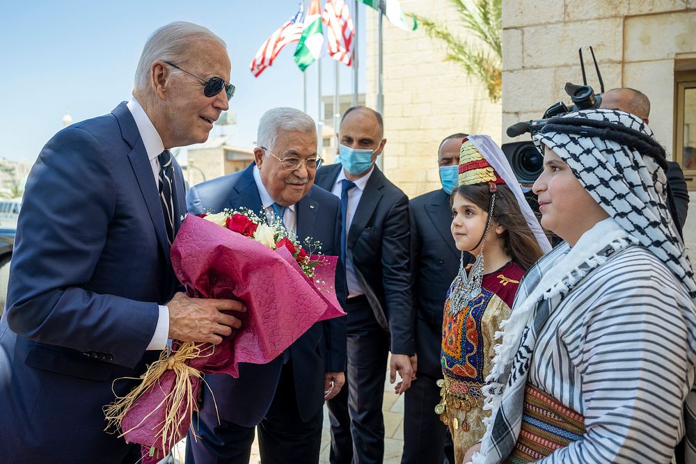 President Joe Biden greets Palestinian Authority President Mahmoud Abbas and two Palestinian children presenting flowers at…