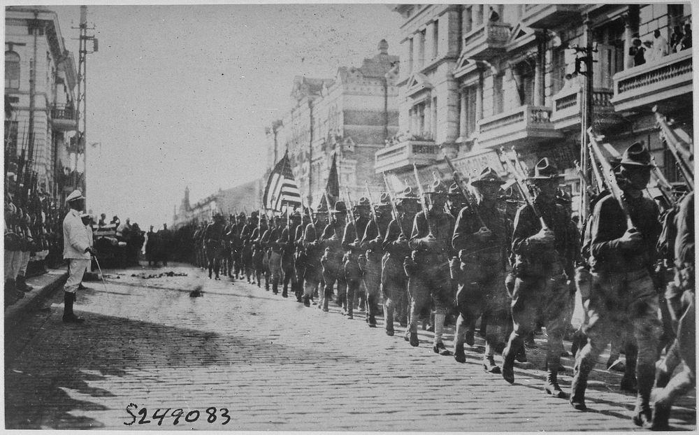 American troops in Vladivostok parading before the building occupied by the staff of the Czecho-Slovaks. Japanese marines…
