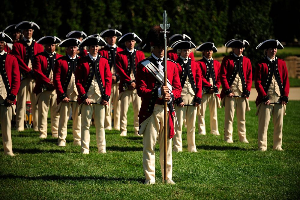 U.S. Soldiers with the Old Guard Fife and Drum Corps stand on the parade field at the Pentagon during the armed forces…