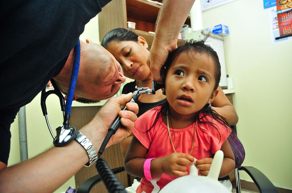 POHNPEI, Federated States of Micronesia (July 12, 2011) Lt. Cmdr. Cory Russell examines the ear canal of a Micronesian girl…