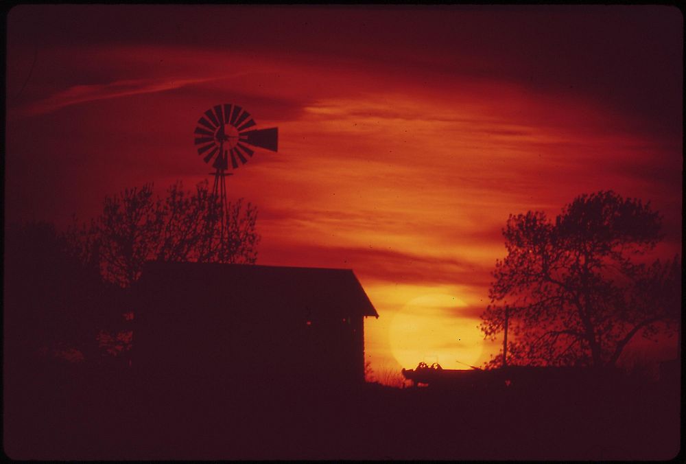 Seward County farm and windmill at sunset, May 1973. Photographer: O'Rear, Charles. Original public domain image from Flickr