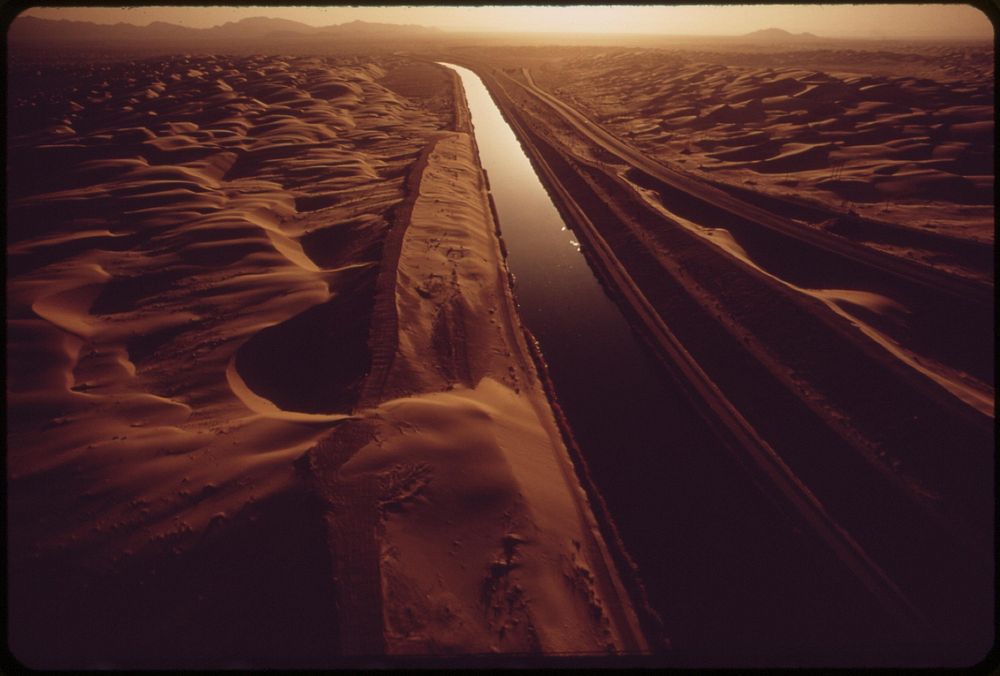 All-American Canal carries Colorado River water through sand-swept area of the Imperial Valley, May 1972. Photographer:…