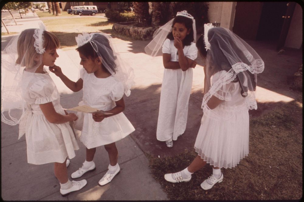 These excited 7 and 8 year olds have just received their first communion at St. Joan of Arc Church, May 1972. Photographer:…