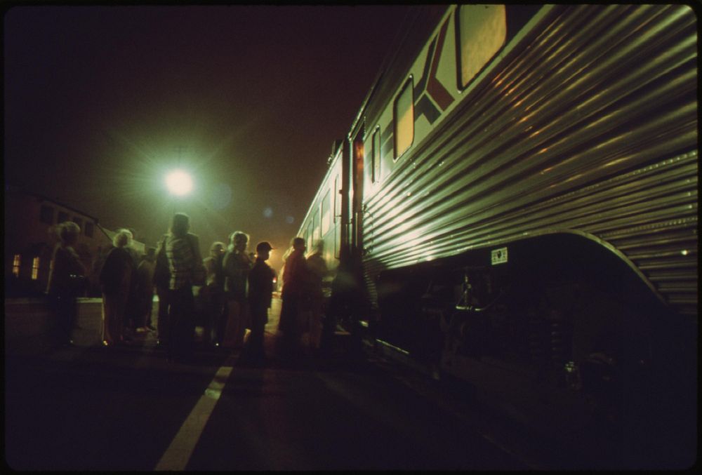 Amtrak passengers board the southbound san diegan as it makes a nighttime stop at the Fullerton, California, station, May…