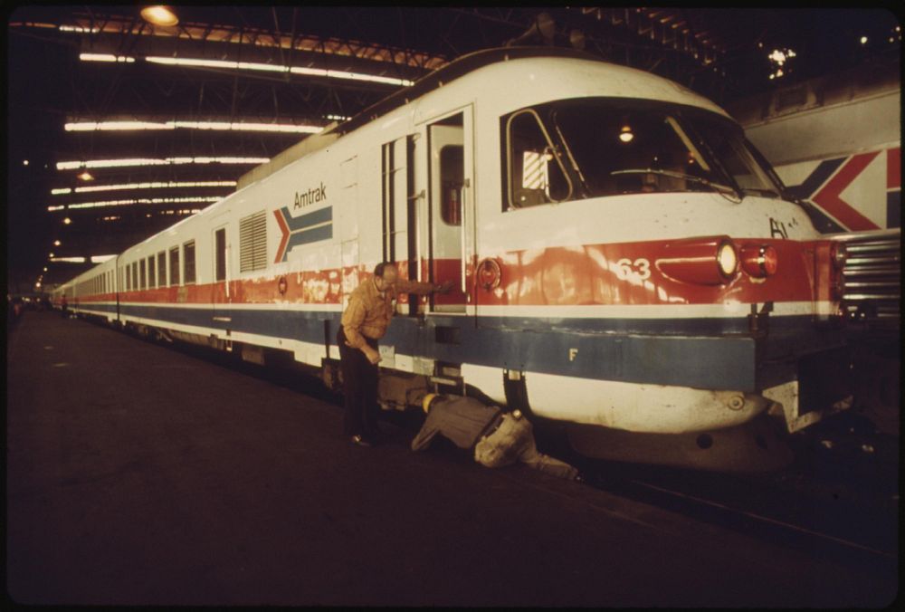 Last minute check of the engine of the Amtrak turboliner passenger train is made before departure from St. Louis, Missouri…