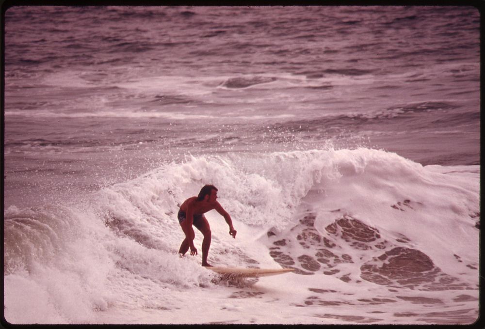 Surfer at Newport Beach, a heavily used recreation spot, May 1975. Photographer: O'Rear, Charles. Original public domain…