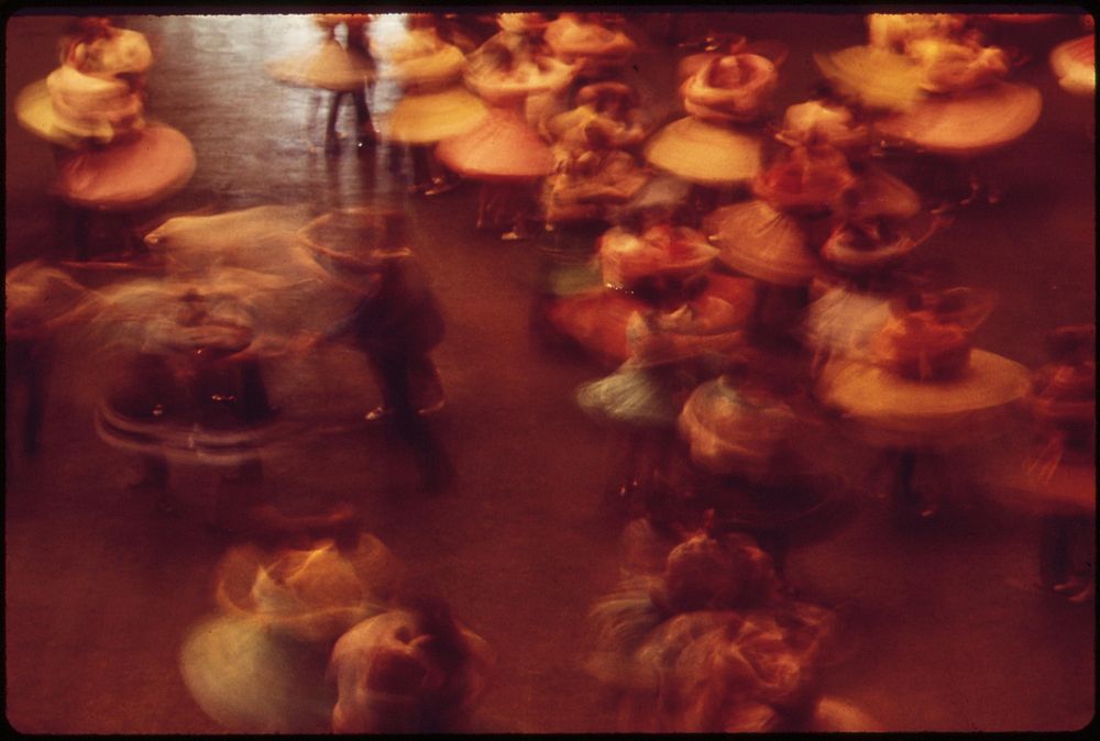 Skirts whirl in the 33rd Annual Square Dance Festival, held in Pershing Auditorium, May 1973. Photographer: O'Rear, Charles.…