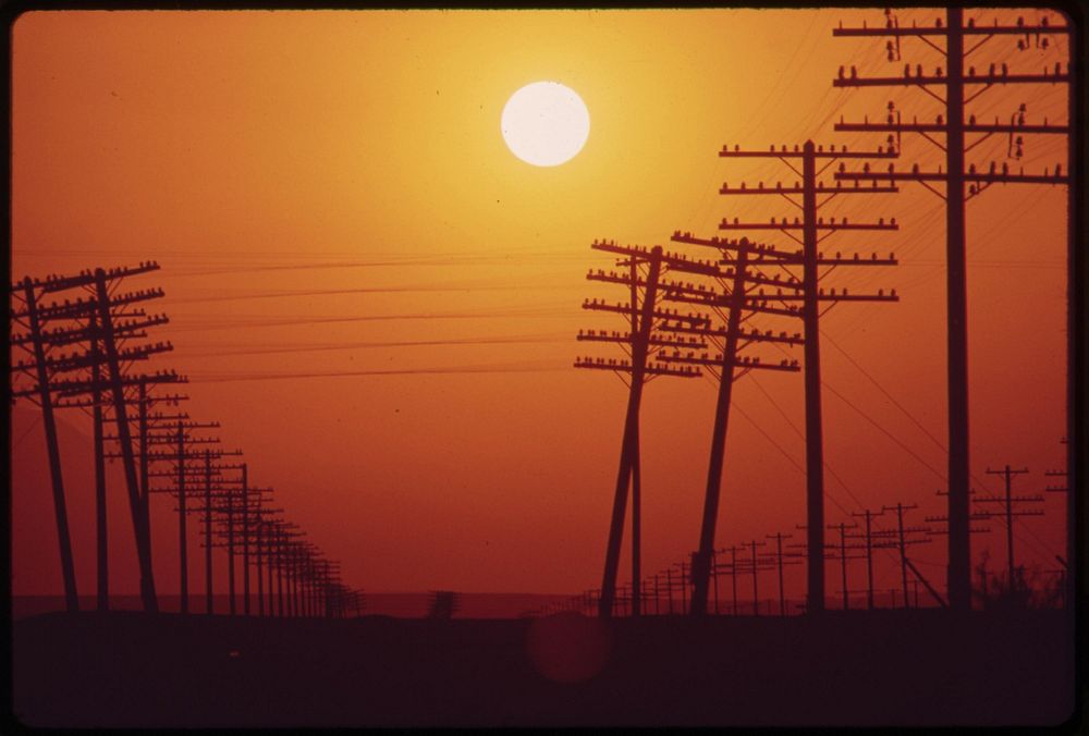 Transmission lines near Salton Sea. Hazy sun is caused by smog from district Los Angeles, May 1972. Photographer: O'Rear…