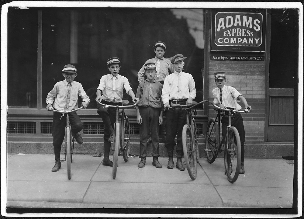 A typical group of Postal Messengers. Smallest on left end, Wilmore Johnson, been there one year, June 1911. Photographer:…