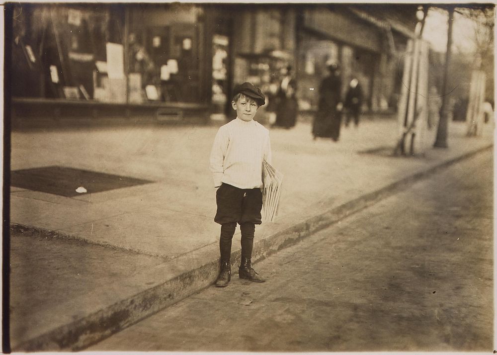 Photograph of William Lerch, 7 year old news-boy who sells for his brother, April 1912. Photographer: Hine, Lewis. Original…