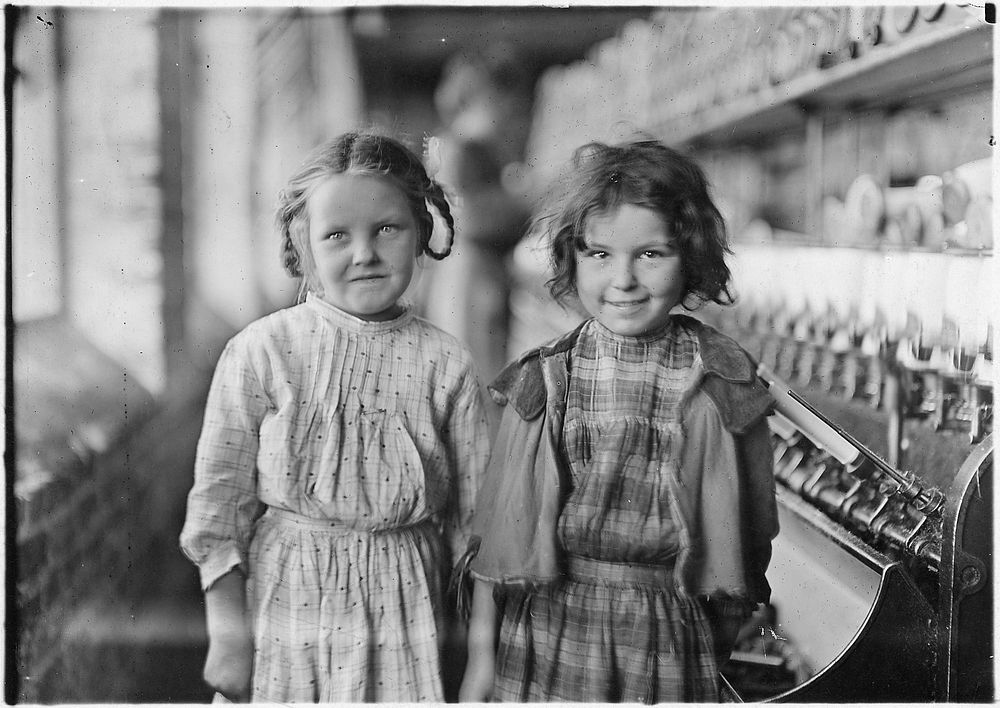 Two of the helpers in the Tifton Cotton Mill. They work regularly. Tifton, Ga, January 1909. Photographer: Hine, Lewis.…