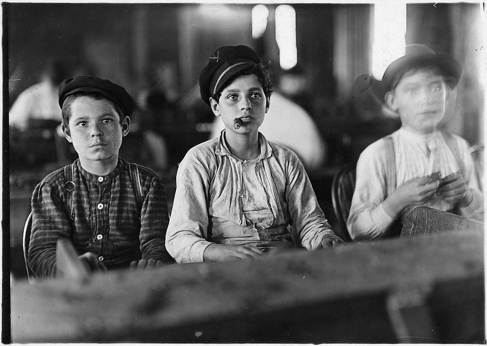 Young cigarmakers in Engelhardt & Co. Three boys looked under 14, January 1909. Photographer: Hine, Lewis. Original public…