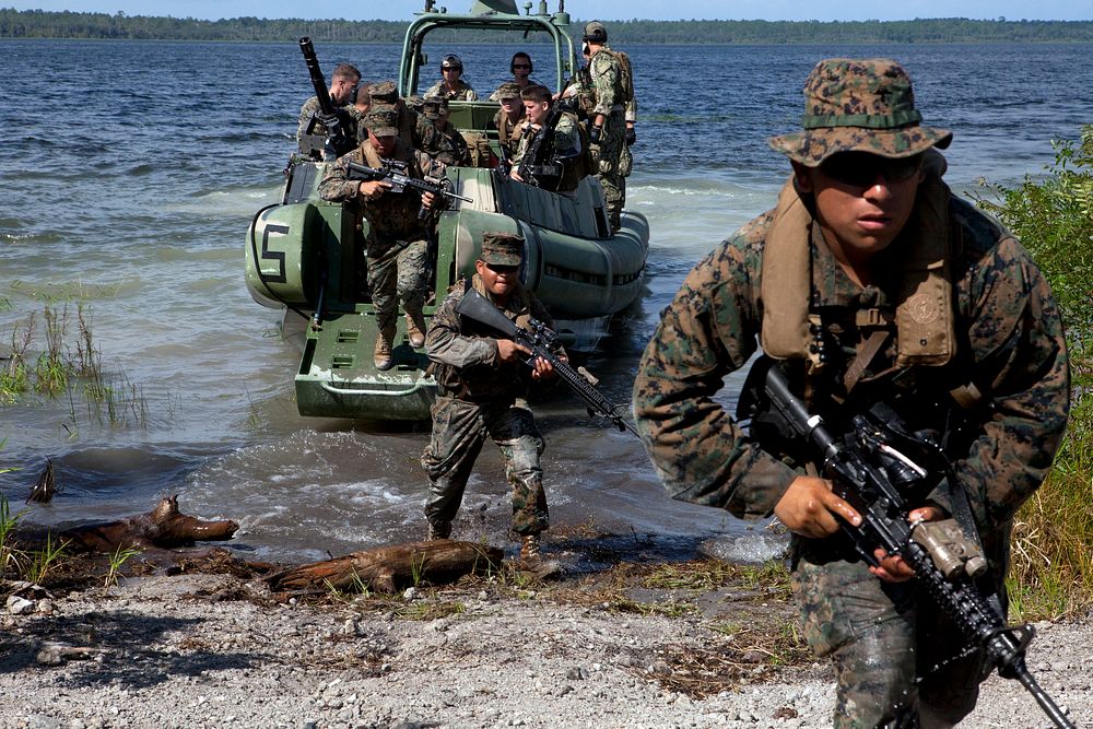 U.S. Marines and Sailors aboard a small unit riverine craft walk on to a beach during Unitas-Partnership of the Americas…