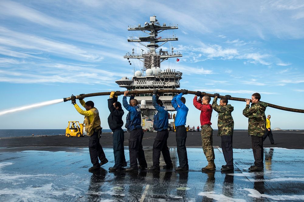 PACIFIC OCEAN (Nov. 12, 2012) ???Sailors and Marines participate in a scrub exercise on the flight deck of the aircraft…