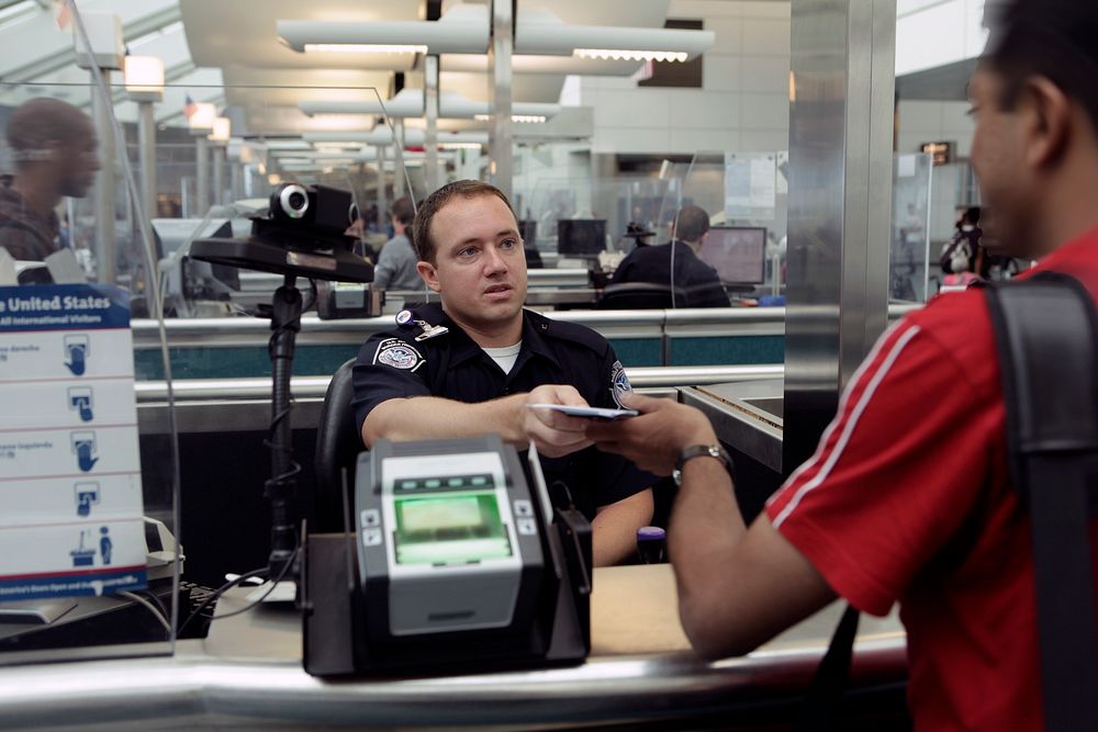 A CBP Officer processes an incoming passenger at the Newark International Airport.