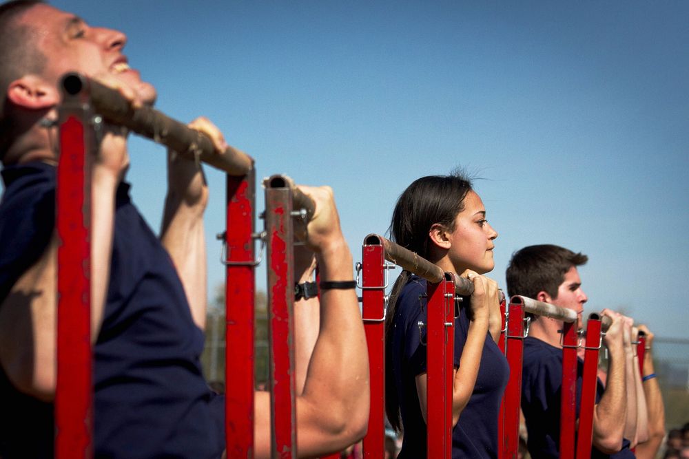 U.S. Marine Corps enlistees conduct the pull-up portion of the initial strength test during a Marine Corps Recruiting…