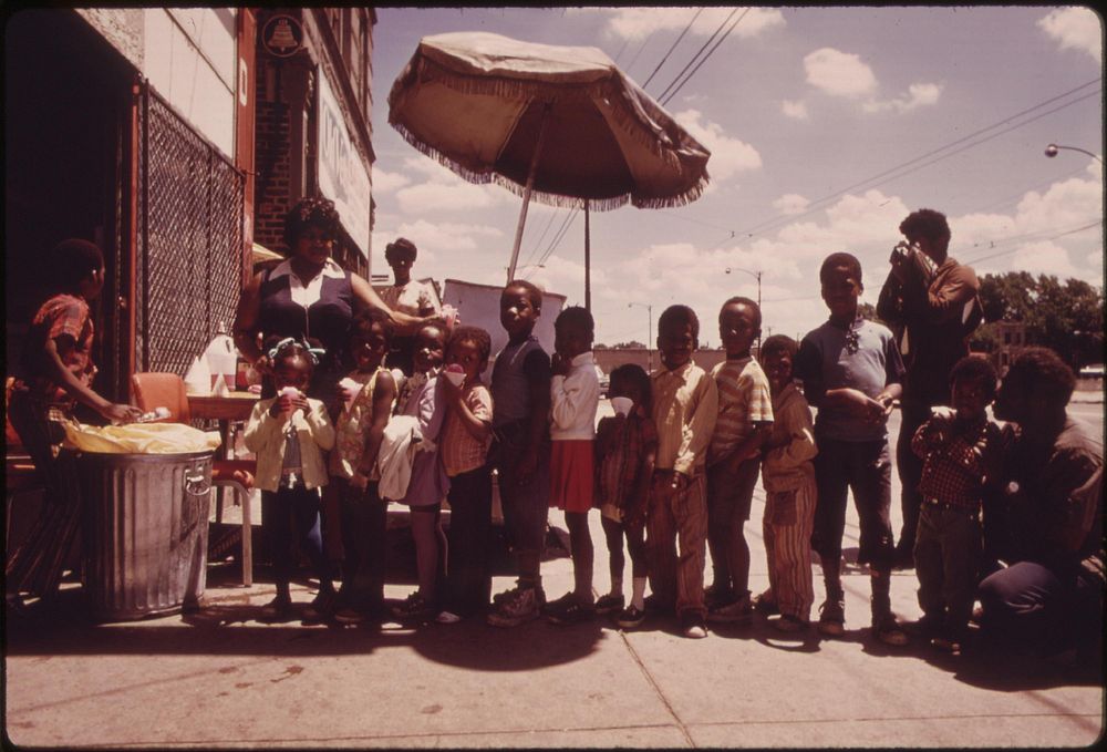 Ghetto Black Children Line Up For Snow Cones From A Sidewalk Vendor On Chicago's West Side In The Summer Of 1973, 06/1973.…