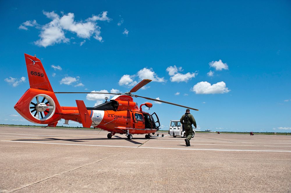 A U.S. Coast Guard Air Station Houston aircrew prepares to launch a MH-65C Dolphin helicopter to medevac of a man 57 miles…
