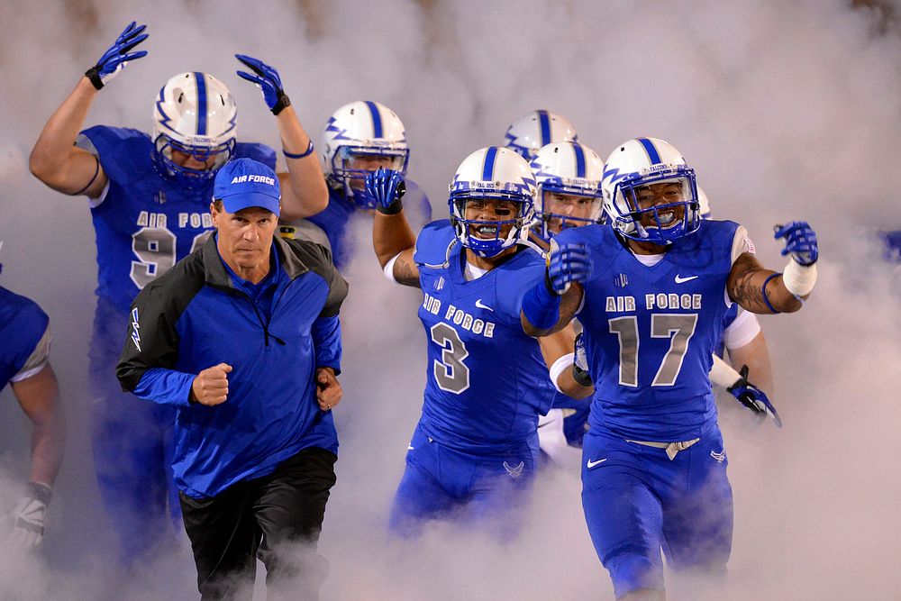U.S. Air Force Academy Falcons head coach Troy Calhoun leads the team into the stadium, as Air Force met conference rival…