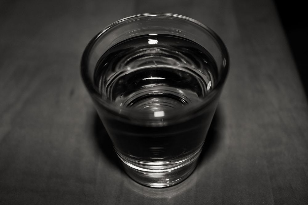 Clear liquid in shot glass. View public domain image source here