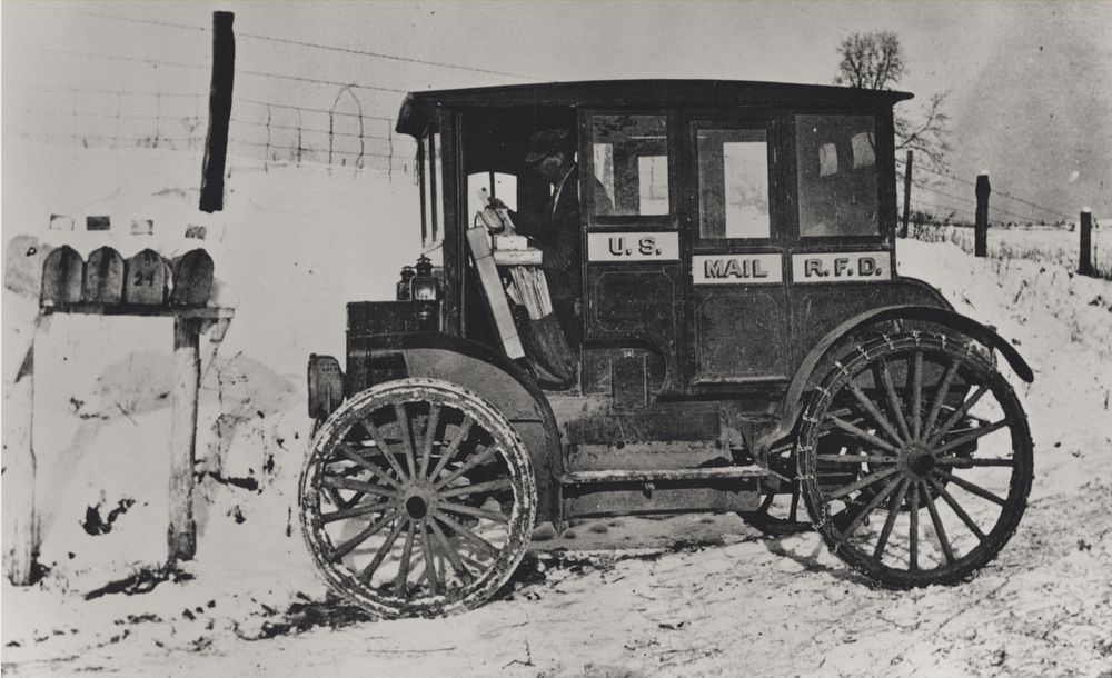 Photograph of rural carrier in automobile at mailboxes