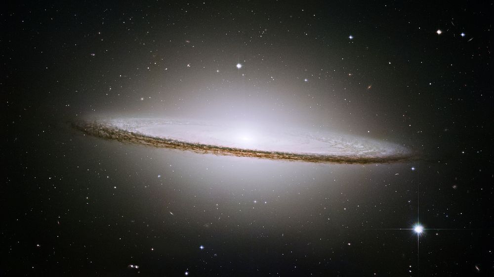 The famous Sombrero galaxy (M104) is a bright nearby elliptical galaxy. The prominent dust lane and halo of stars and…