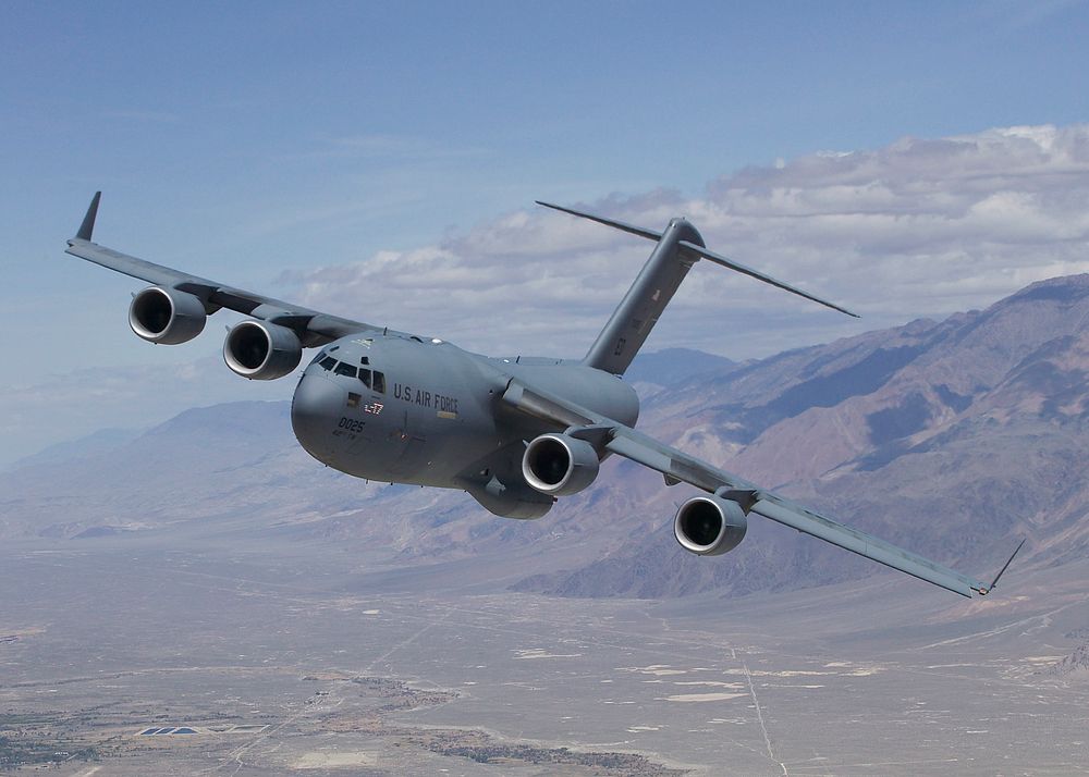 A U.S. Air Force C-17 Globemaster III T-1 flies over Owens Valley, California, for a test sortie. Edwards Air Force Base…