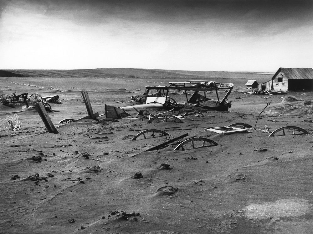 Buried machinery in barn lot in Dallas, South Dakota, United States during the Dust Bowl, an agricultural, ecological, and…