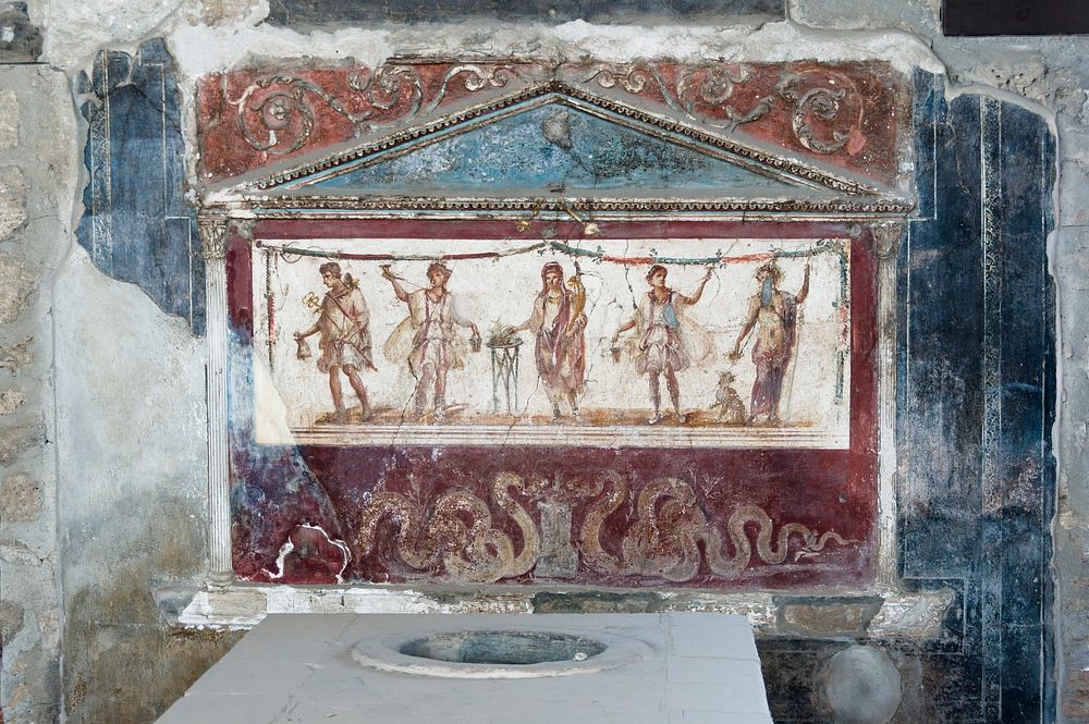 The thermopolium of Lucius Vetutius Placidus in Pompeii, focus on the lararium. Italy.