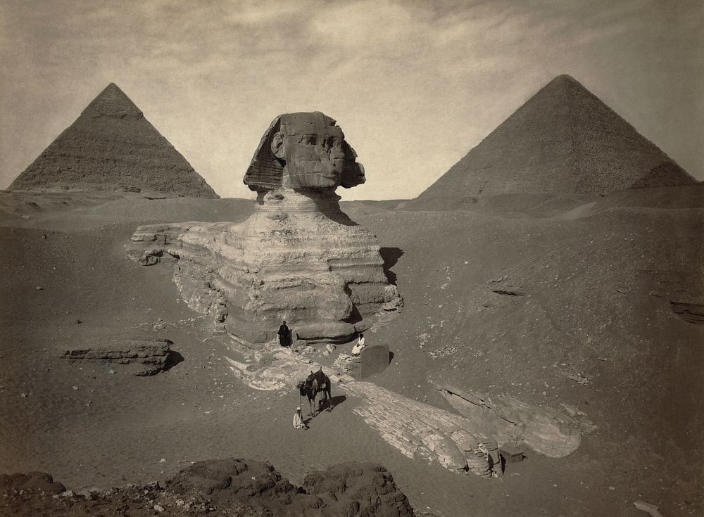The Great Sphinx of Giza, partially excavated, with two pyramids in background. Albumen print.