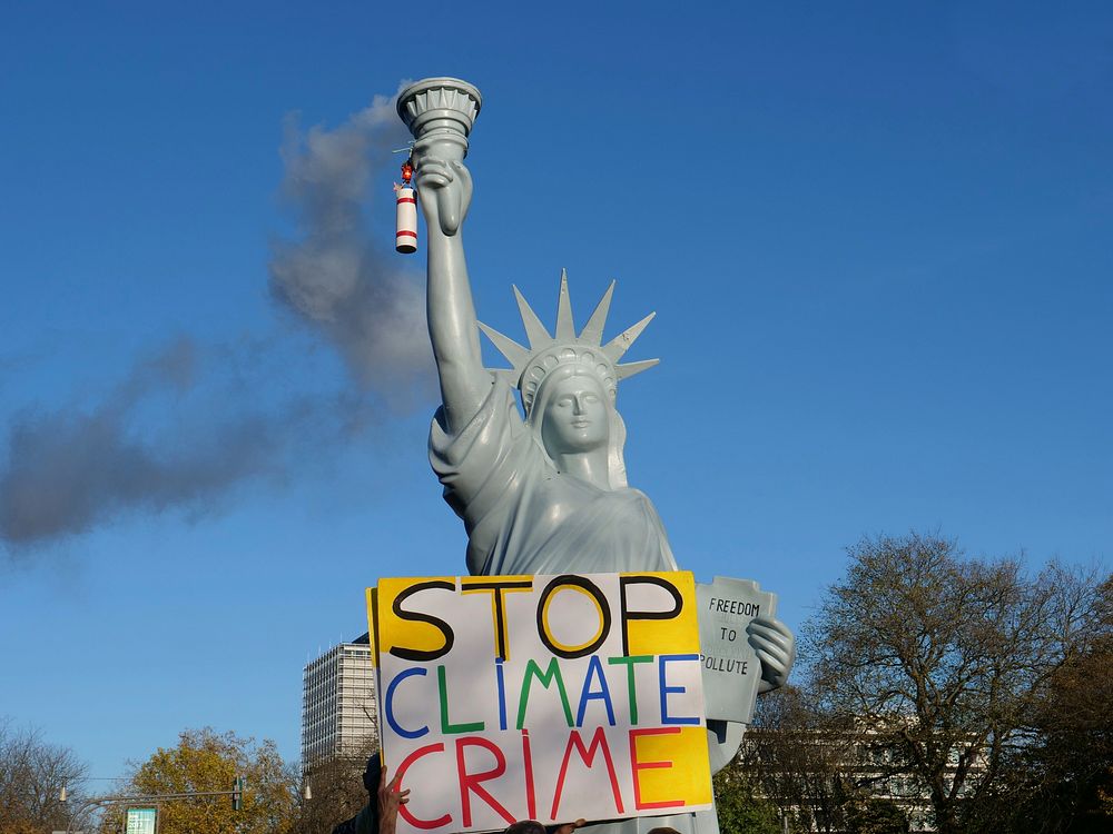 Statue of Liberty with smoky flame and protest text 'Stop Climate Crime', demonstration in Bonn, a few days before 2017…