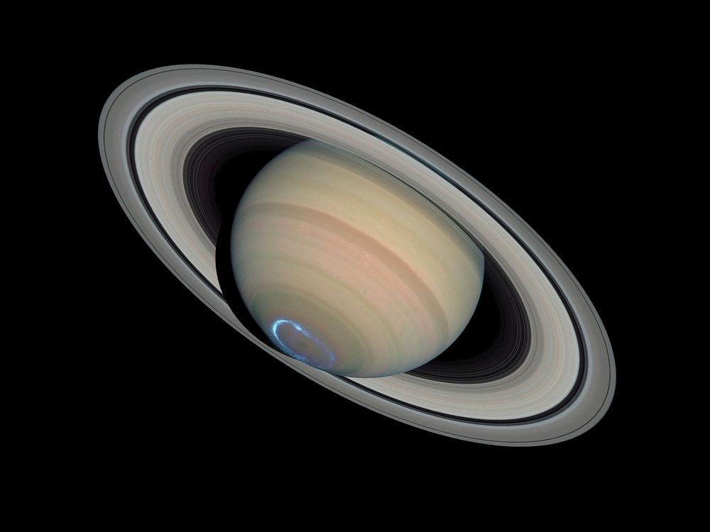 Photomontage of Saturn with a false-colour image of ultraviolet aurora taken with the Imaging Spectrograph on January 24…