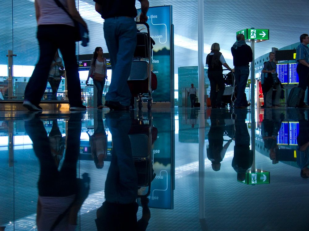 Departing passengers at airport. View public domain image source here