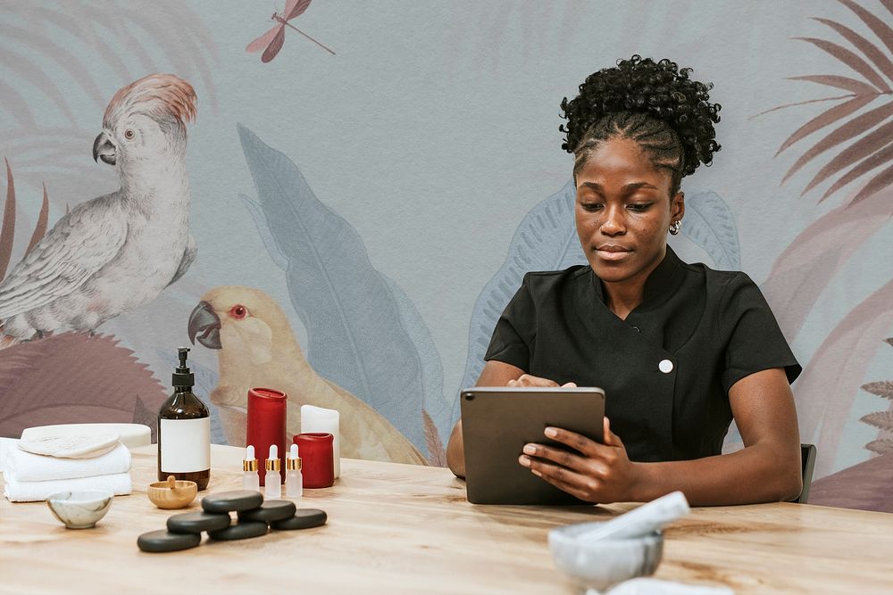 Wellness center, black staff woman using tablet