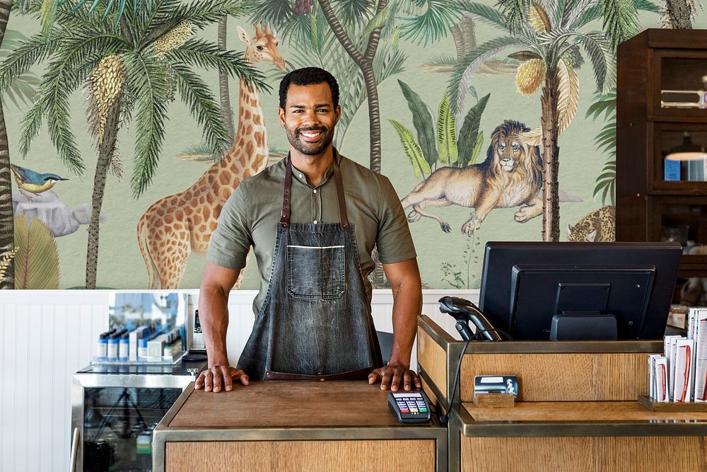 Cafe small business owner smiling at the counter